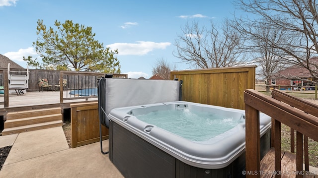 wooden deck featuring a hot tub