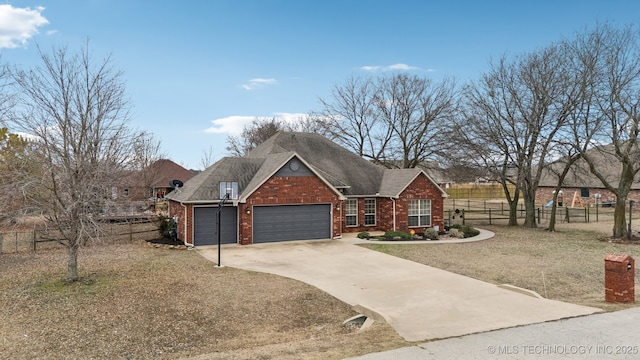 view of front of home with a garage and a front lawn