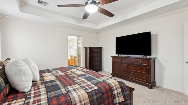 bedroom featuring a raised ceiling, crown molding, light carpet, and ceiling fan