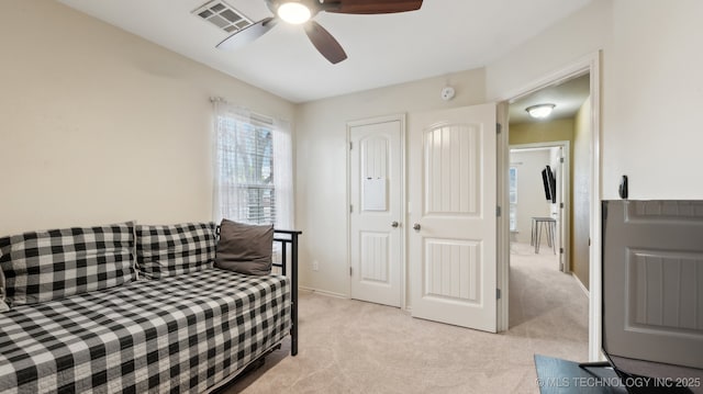 bedroom featuring light carpet and ceiling fan