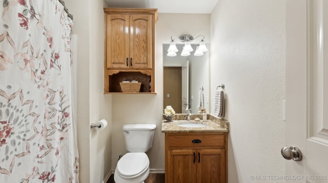 bathroom featuring vanity, a shower with shower curtain, and toilet