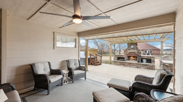 view of patio / terrace featuring an outdoor fireplace and exterior kitchen