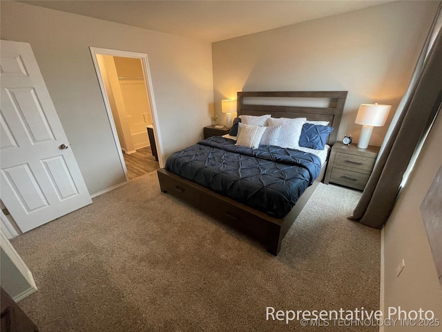 carpeted bedroom with connected bathroom