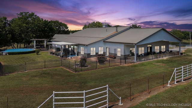 view of back house at dusk