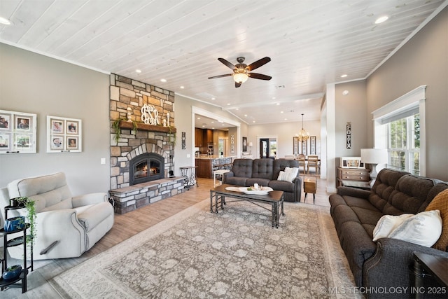 living room with hardwood / wood-style floors, a fireplace, ornamental molding, and wooden ceiling