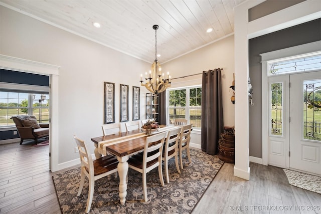 dining room with lofted ceiling, wooden ceiling, a notable chandelier, and light wood-type flooring