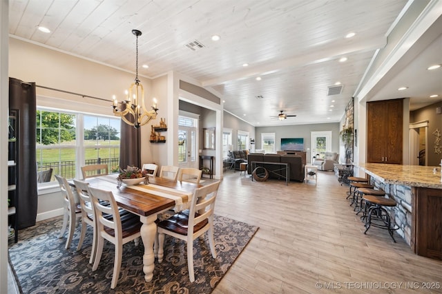 dining room with crown molding, plenty of natural light, wood ceiling, and light wood-type flooring