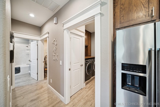 hall featuring separate washer and dryer and light wood-type flooring