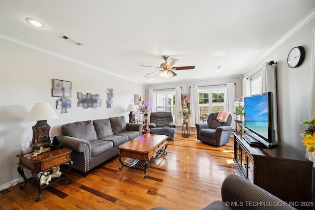 living room featuring ornamental molding, ceiling fan, and light hardwood / wood-style floors