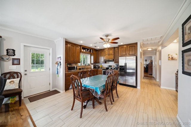 dining room featuring crown molding and ceiling fan