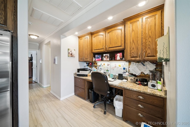 home office with crown molding and built in desk