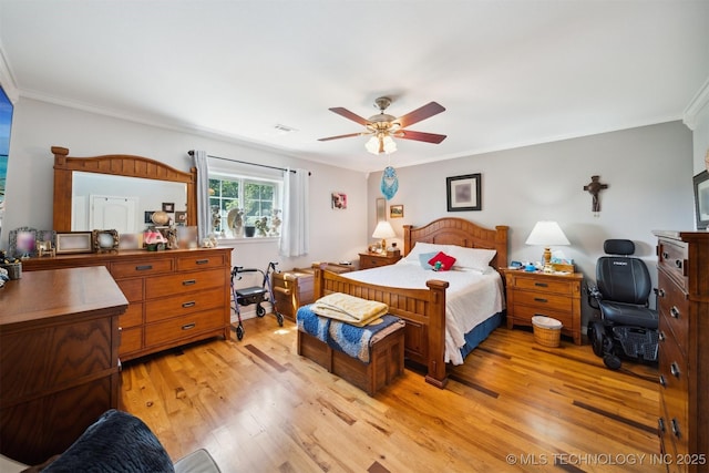 bedroom featuring crown molding, ceiling fan, and light wood-type flooring