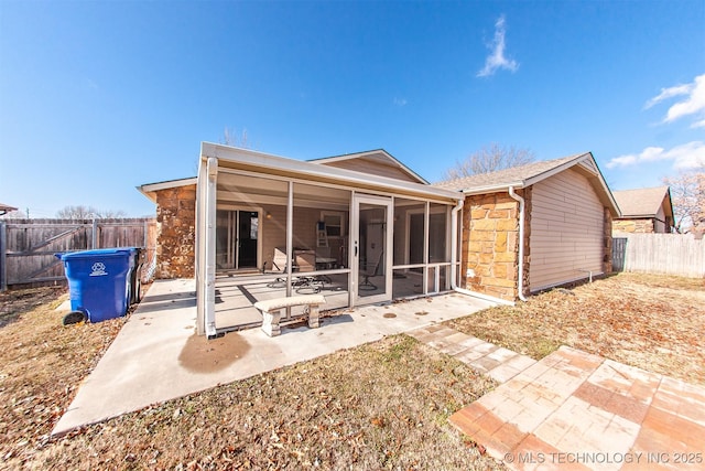 back of property featuring a patio and a sunroom