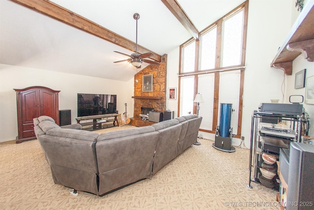 carpeted living room featuring ceiling fan, a stone fireplace, high vaulted ceiling, and beam ceiling