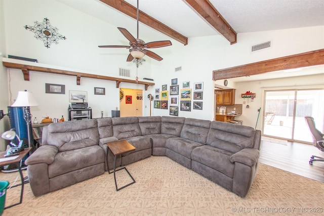 living room with ceiling fan, beam ceiling, high vaulted ceiling, and light hardwood / wood-style flooring