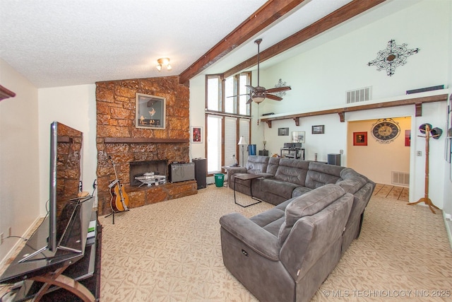 living room with ceiling fan, high vaulted ceiling, a textured ceiling, a stone fireplace, and beamed ceiling