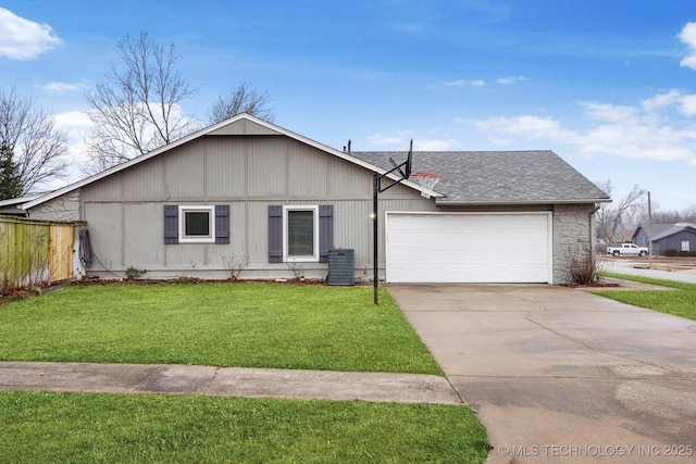 single story home featuring cooling unit, a garage, and a front lawn