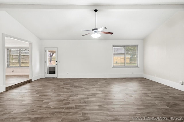 interior space featuring vaulted ceiling with beams, wood-type flooring, a healthy amount of sunlight, and ceiling fan