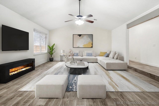 living room with vaulted ceiling, ceiling fan, and light hardwood / wood-style floors