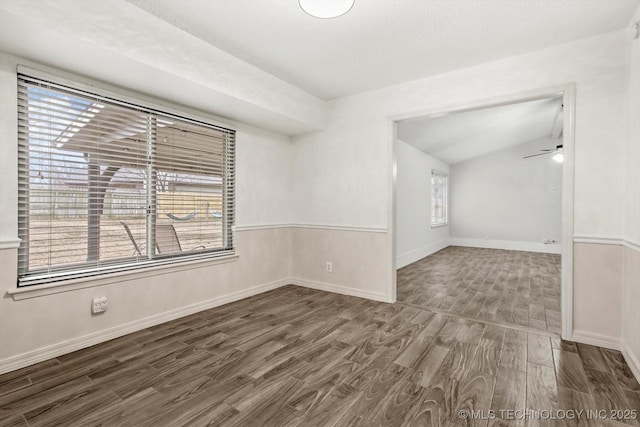 spare room with hardwood / wood-style flooring, ceiling fan, and lofted ceiling