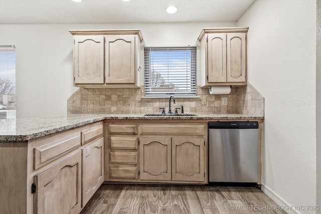 kitchen with backsplash, stainless steel dishwasher, sink, and light brown cabinets