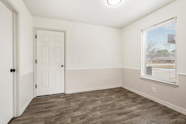 spare room featuring dark wood-type flooring