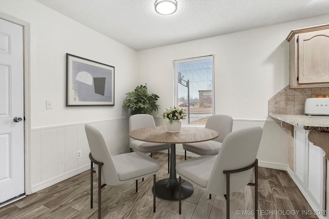 dining space featuring dark hardwood / wood-style floors and a textured ceiling