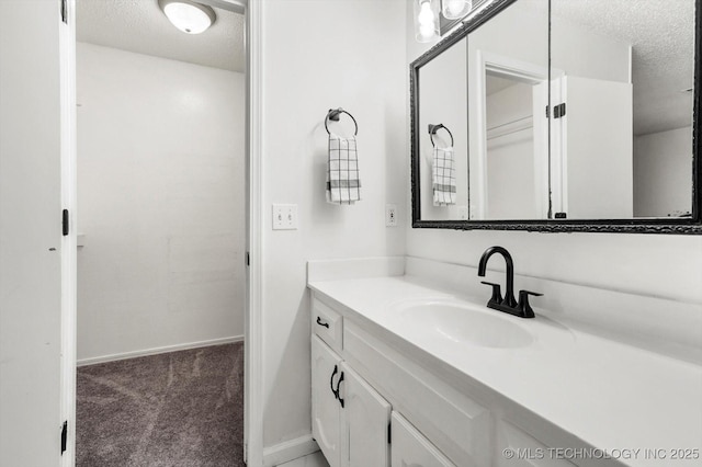 bathroom with vanity and a textured ceiling