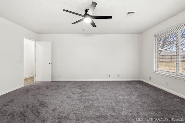 carpeted empty room with a textured ceiling and ceiling fan