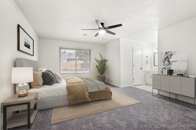 bedroom with ceiling fan, ensuite bathroom, carpet floors, and a textured ceiling