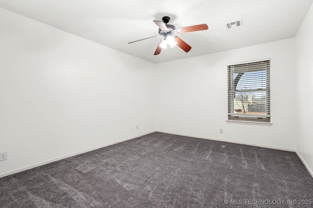 carpeted spare room with ceiling fan