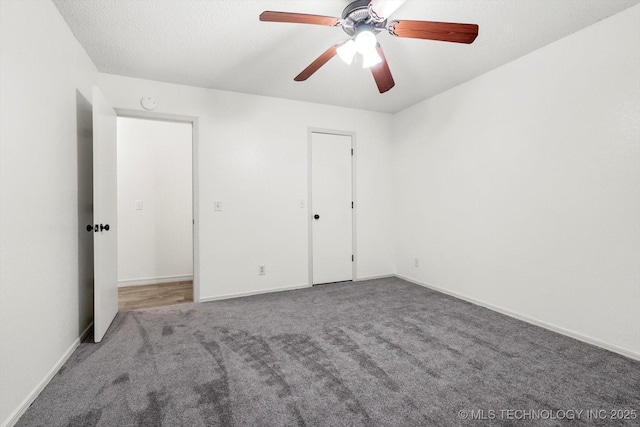 unfurnished bedroom with ceiling fan, carpet, and a textured ceiling