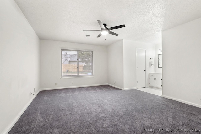 unfurnished room with ceiling fan, carpet flooring, and a textured ceiling