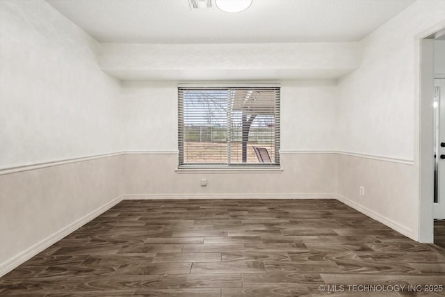 empty room with dark wood-type flooring