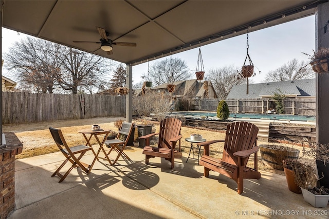 view of patio featuring a fenced in pool and ceiling fan