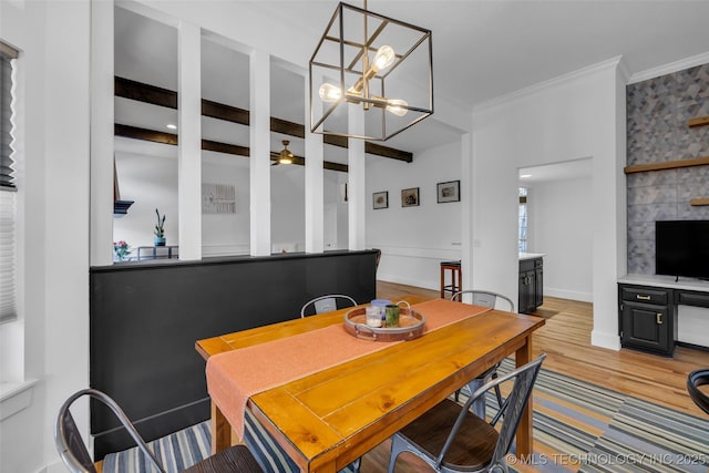 dining room featuring light hardwood / wood-style flooring, ornamental molding, and beamed ceiling