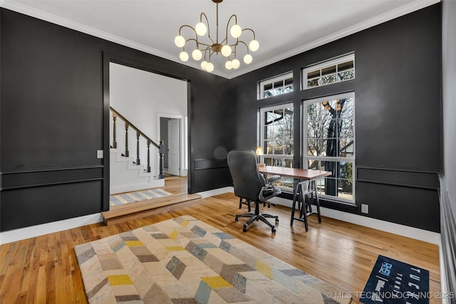 office area with an inviting chandelier, hardwood / wood-style floors, and ornamental molding