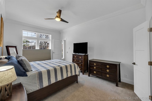 bedroom featuring ornamental molding, light colored carpet, and ceiling fan