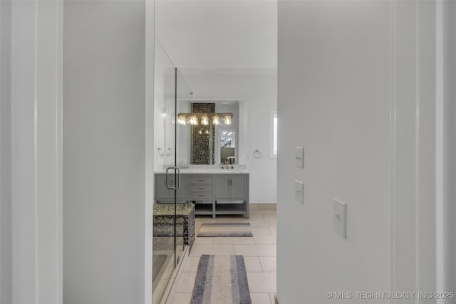 bathroom with vanity, tile patterned flooring, a shower with shower door, and crown molding