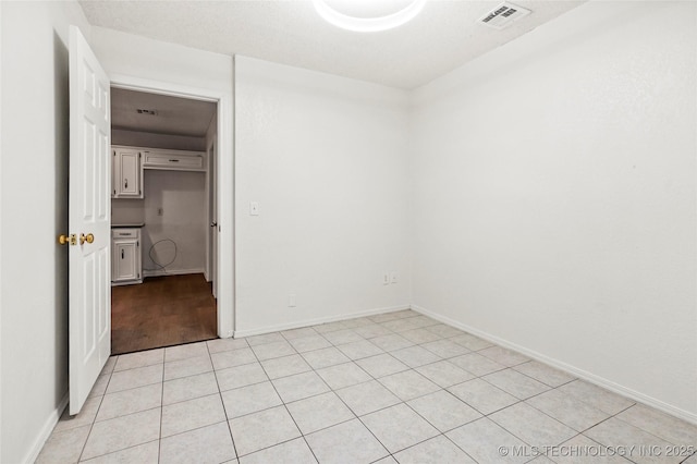 spare room featuring light tile patterned floors