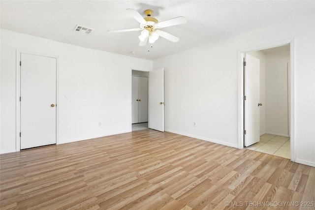 empty room featuring ceiling fan and light hardwood / wood-style flooring