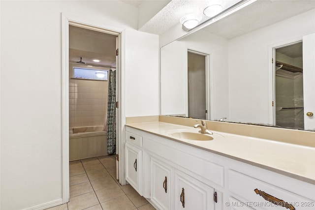 bathroom with shower / bath combination with curtain, vanity, and tile patterned flooring