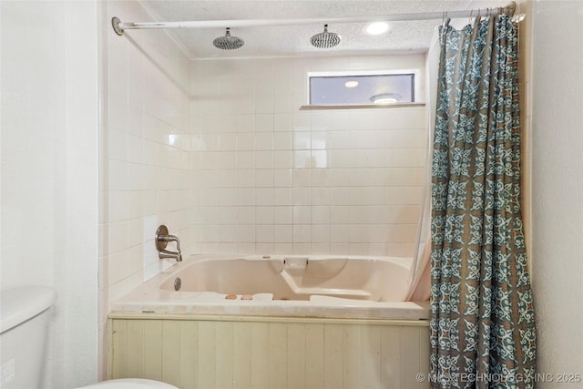 bathroom with shower / bath combination with curtain, toilet, and a textured ceiling