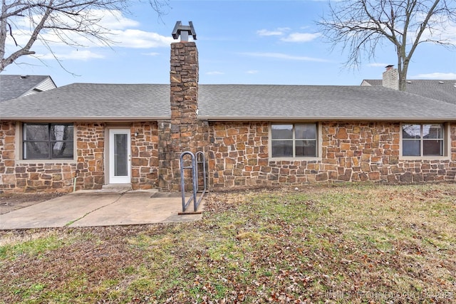 rear view of house with a yard and a patio