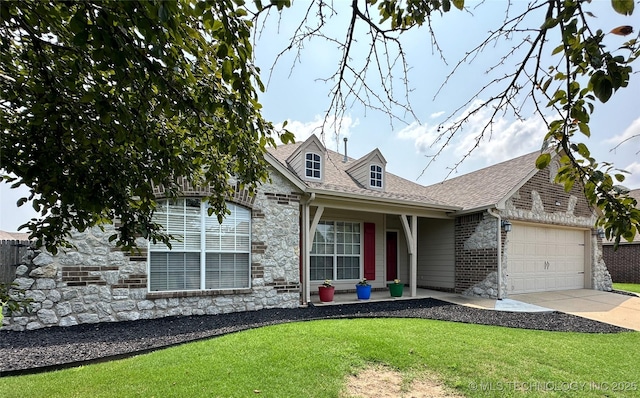 view of front of property featuring a garage and a front lawn