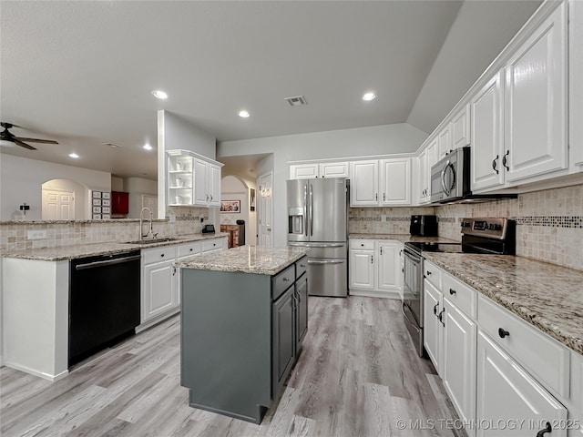 kitchen with white cabinetry, sink, a center island, and appliances with stainless steel finishes