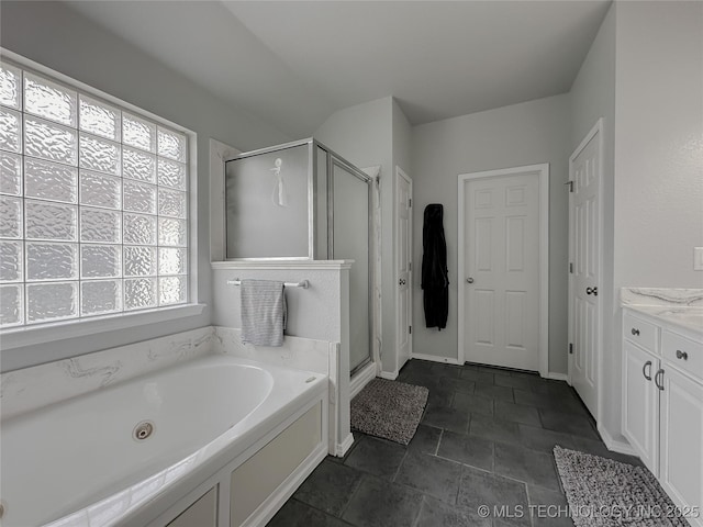 bathroom featuring vanity and shower with separate bathtub