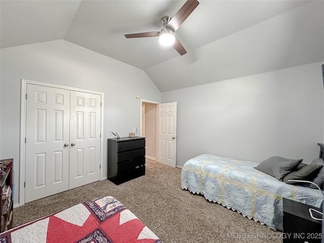 bedroom with ceiling fan, carpet flooring, vaulted ceiling, and a closet