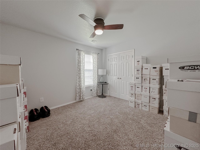 unfurnished bedroom featuring carpet floors, a closet, and ceiling fan