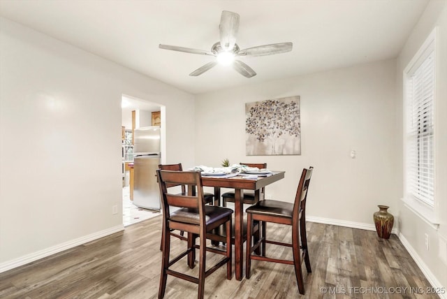 17121 E 120th St, Collinsville, OK 74021 - dining area featuring wood finished floors, a ceiling fan, and baseboards